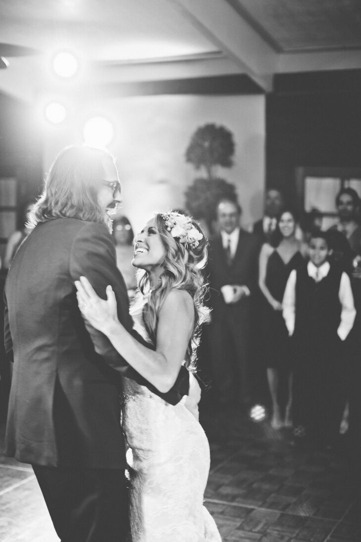 As Marisa and Kyle took their first dance at the reception, her long, wavy hair flowed with the movements. Ivory and pink roses accented the sides of her beautiful hairstyle, incorporating the garden-inspired theme into her own look.