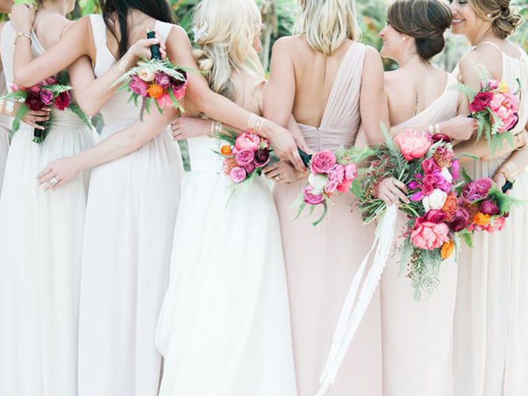 Bridesmaids standing with arms around each other