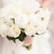 Lindsay carried a simple bouquet of white peonies and some roses. Peonies were not in season during the time of her winter wedding, so her florist imported them from New Zealand.