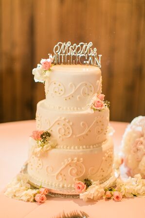 White Wedding Cake With Piping and Pink Flowers