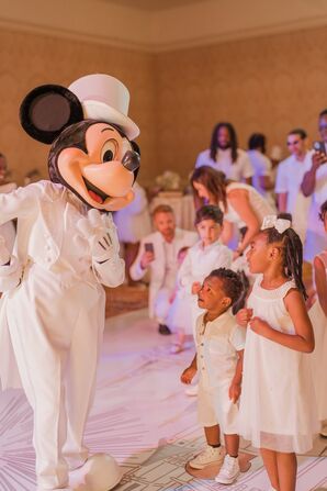 Mickey Mouse in White Tuxedo Greets Kids in White at Disney World Reception