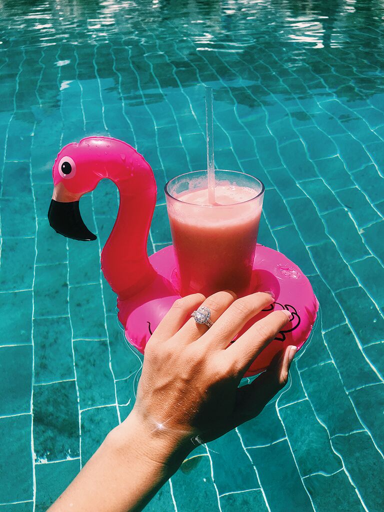 Engagement ring selfie idea with a cocktail pool float