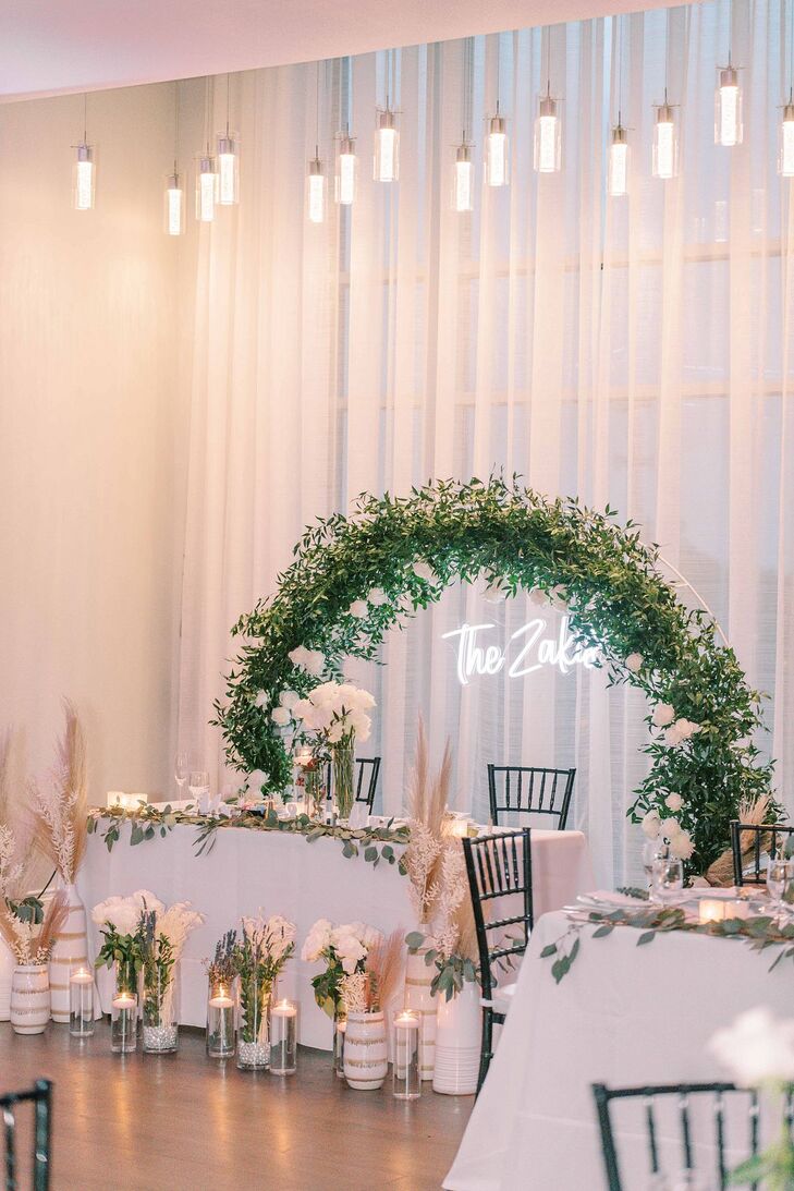 Sweetheart Table With Greenery Arch and Custom Neon Sign