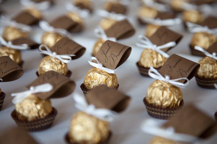 Ferrero Rocher chocolates were used to hold the escort cards. These edible treats were decorated with an ivory ribbon tie and topped with a pearl detail.