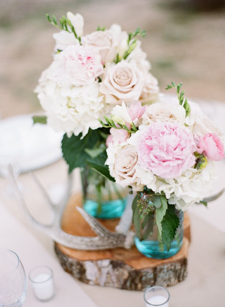 Antlers, slices of wood and simple floral arrangements in cheerful blue mason jars topped all of the tables during cocktail hour.