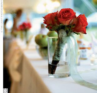 Guests at Lauren and Travis' reception mingled among tables topped with tall vases full of crab apples, pink roses, and bells of Ireland.
