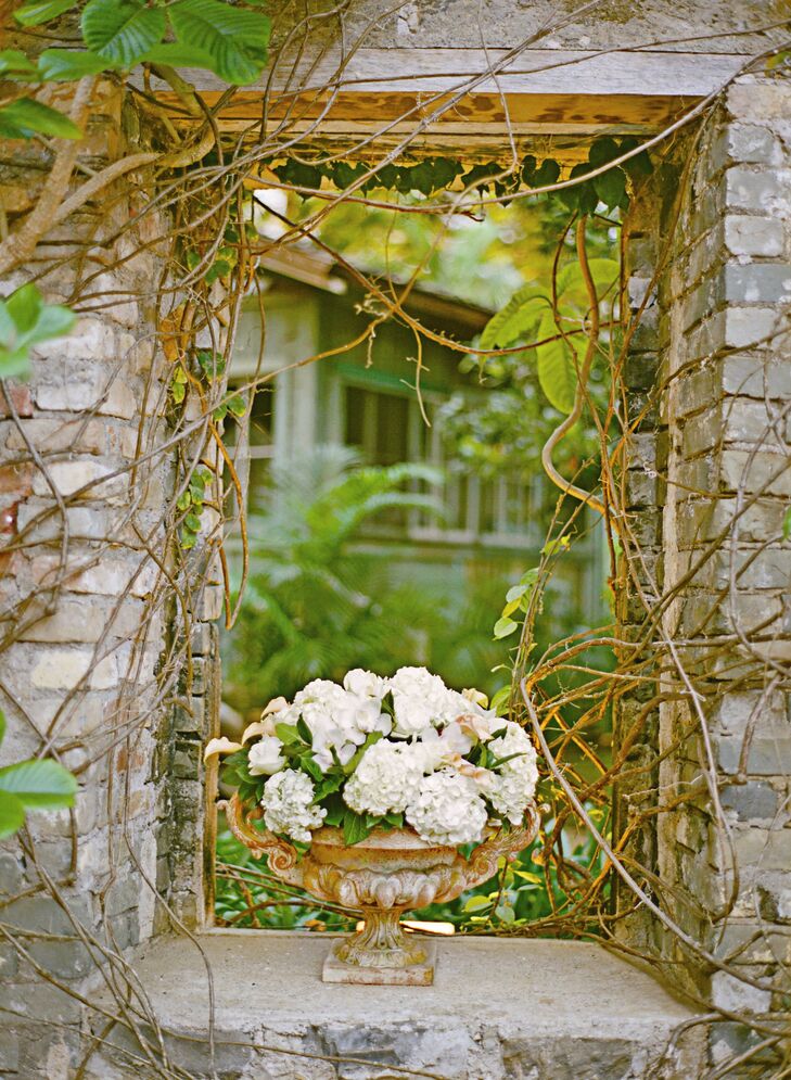 Since their venue was full of interesting natural decor, Mackenzie and Tim only added a few, simple elements, like this rustic-looking urn filled with hydrangeas and cymbinium orchids.