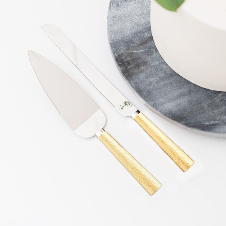 Hammered gold and silver cake cutting set. 