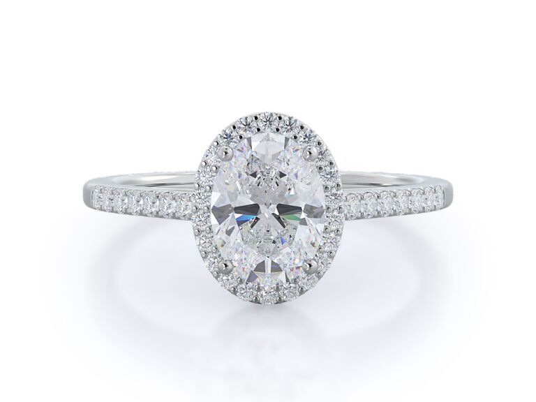 oval-cut halo engagement ring in a cathedral setting