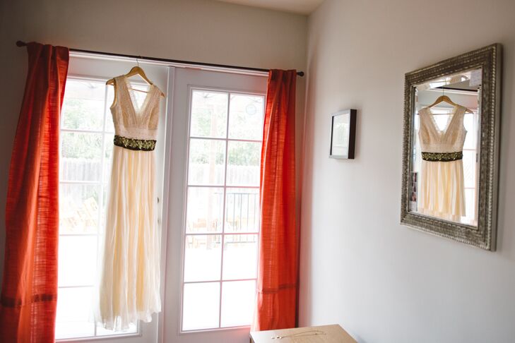 Emily wore an ivory wedding dress with a deep V-neckline and green belt. "With the help of a good seamstress, I transformed my mom’s super-1970s dress to a style that I loved and that was personal to me," Emily says. "I didn’t have to waste resources on something I would wear only once, and at the same time created a new family heirloom."