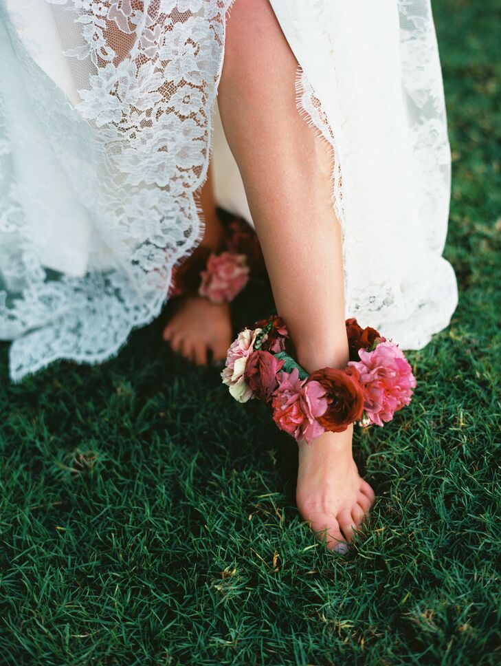 In keeping with Hawaiian traditions, Laura donned ankle lei made with deep burgundy garden roses and pink plumeria.