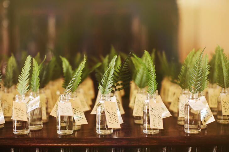 Hailey worked with her florist to incorporate green fern into most, if not all, of the wedding day arrangements. Guests took home wedding favors of small fern placed inside a small glass bottle labeled with a tag.