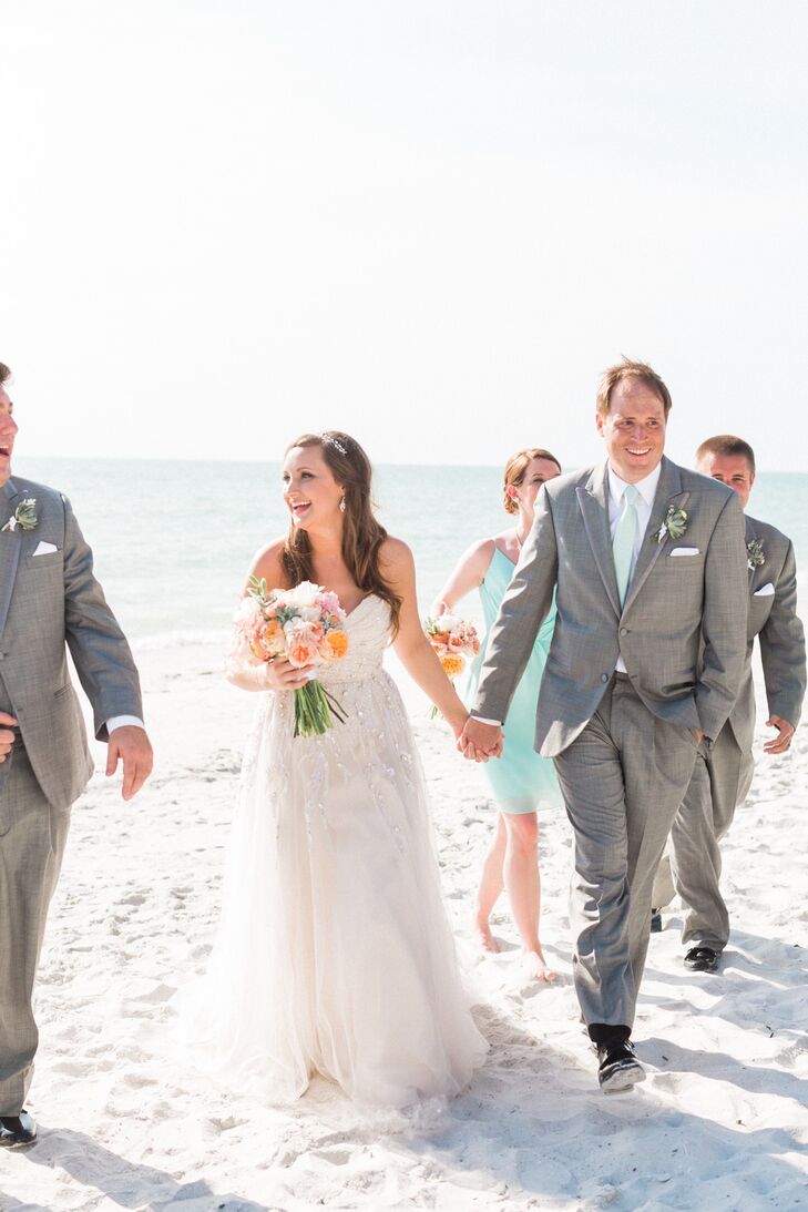 Dallas and his groomsmen matched to a T with light gray tuxedos from Men’s Wearhouse. For some color, they added mint ties to match the bridesmaid dresses and natural succulent boutonnieres wrapped in white ribbon. Their white shirts, however, had a personalized accent. “Dallas bought each of the groomsmen, ushers and dads custom cuff links from England,” Stephanie says. “One cuff link had a map of where the guy was from and the other had a map of Naples, Florida.”