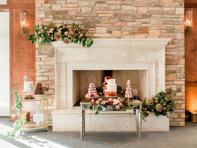 wedding cake table display with stone fireplace as the backdrop