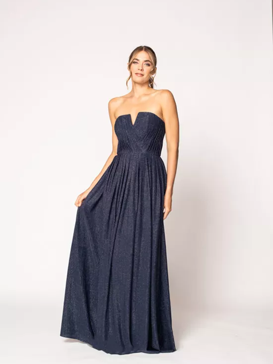 A model wears a navy blue strapless dress.