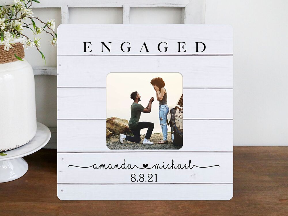 White wooden style background with 'Engaged' in simple serif above photo and names below