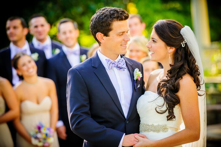 Brian and his groomsmen wore navy suits by Vera Wang for Men's Wearhouse. They accessorized with plaid pink and blue bow ties.