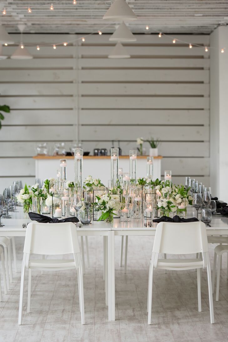 Modern Reception Table With White Chairs, Taper Candles and Greenery