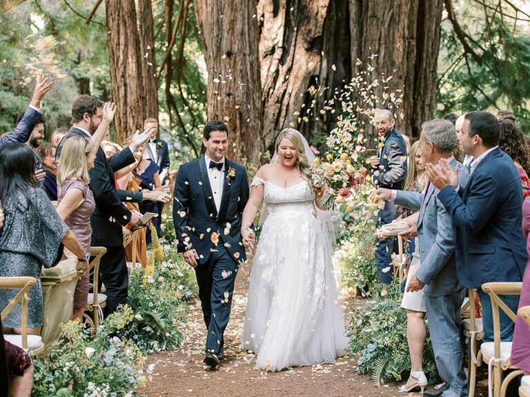 bride and groom recessional with guests tossing flower petals