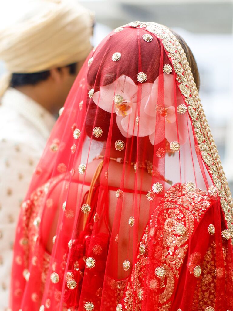 wedding hair flowers white flower under red veil