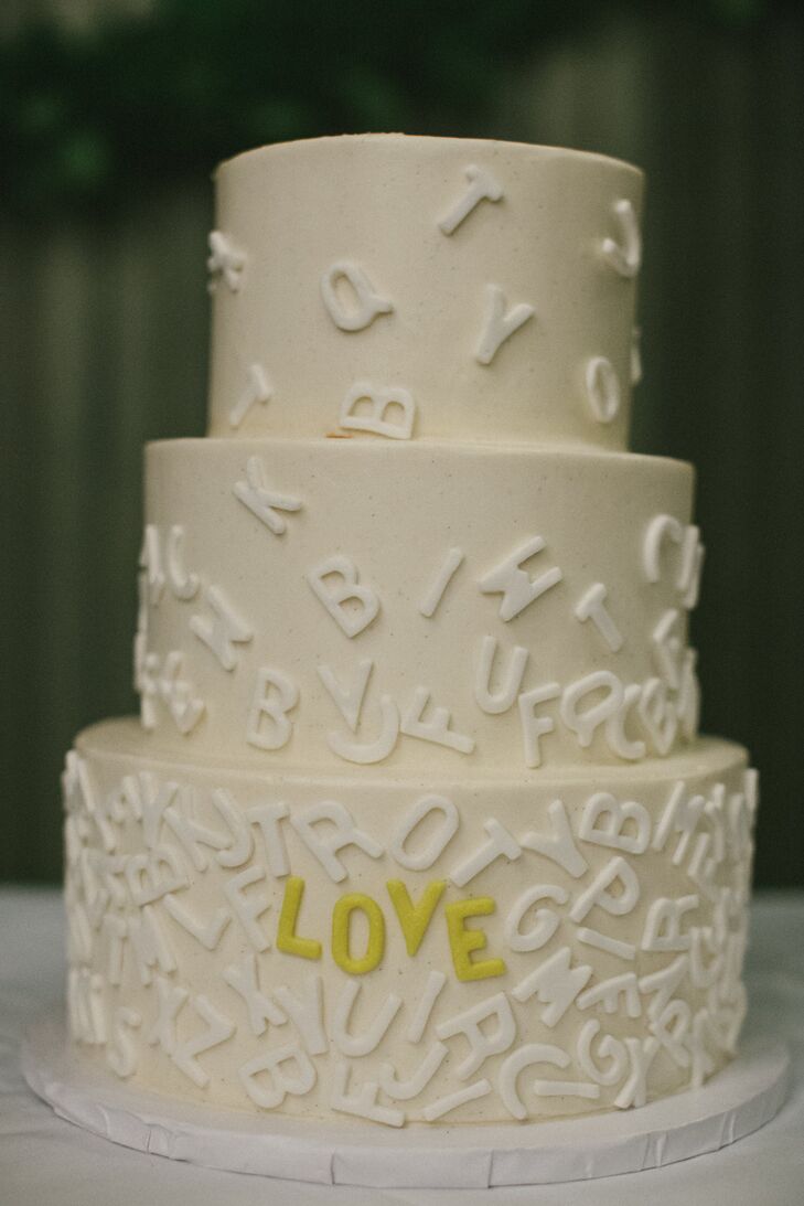 The buttercream cake was topped with white cascading alphabet letters; yellow ones spelled out “love.”