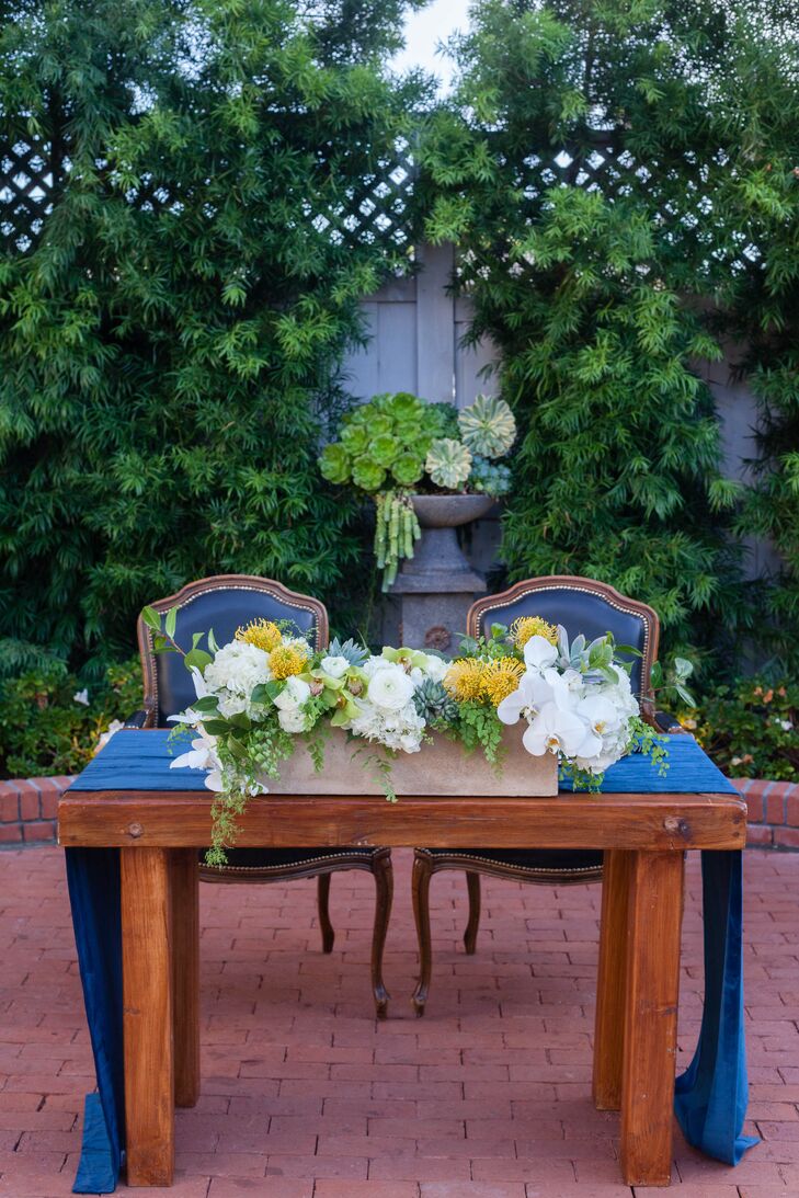 Orchid and Pincushion Protea Sweetheart Table Centerpiece