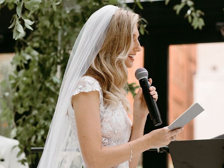Bride sharing wedding vows during wedding ceremony