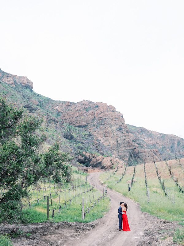 Western engagement photo in a vineyard. 