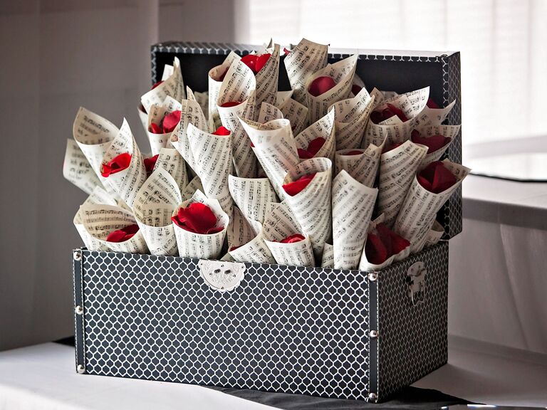Rose petals in music sheet cones. 