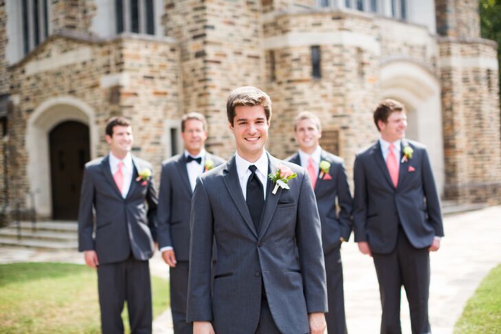 Michael and his groomsmen wore matching gray suits for the wedding. To stand out from the rest of the guys, Michael sported a black tie, while the groomsmen wore colorful coral ties with matching pocket squares.