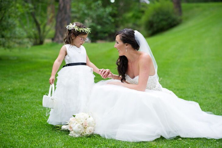 For her flower girl duties, Ashley's niece Alexa wore a white tulle dress with a black satin belt from Chasing Fireflies and a floral crown.