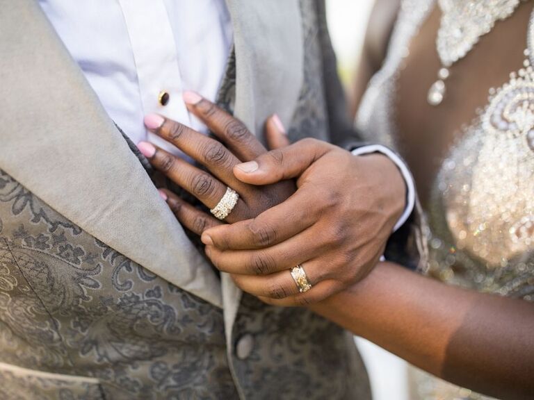 Couple with wedding rings holding hands
