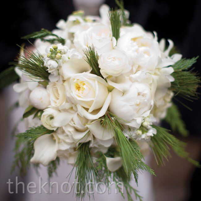 Even though peonies weren’t in-season, the florist found some to add to Katie’s white bouquet, which also included roses, calla lilies and evergreen sprigs.