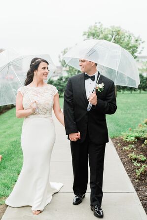 Bride and Groom Under Clear Umbrellas at Rainy Wedding