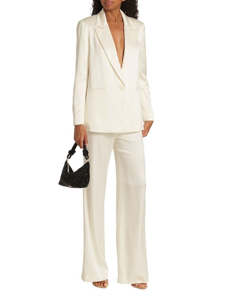Model wears a chic silk pant suit. 