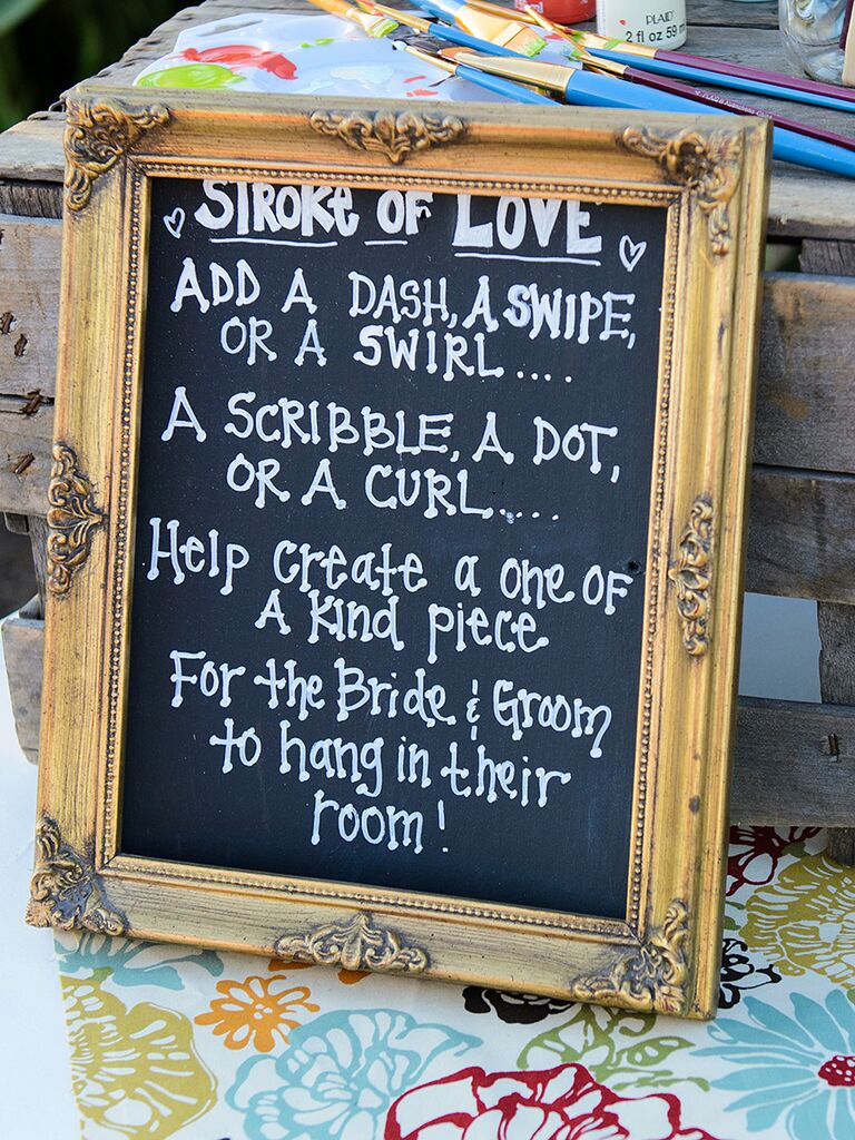 Creative wedding guestbook idea with a chalkboard sign
