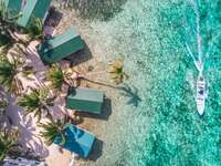 Tobacco Caye aerial barrier reef with boat in Belize, Central America