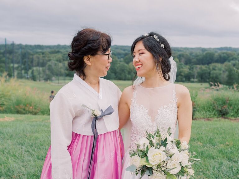 Bride and her mother pose for the camera. 