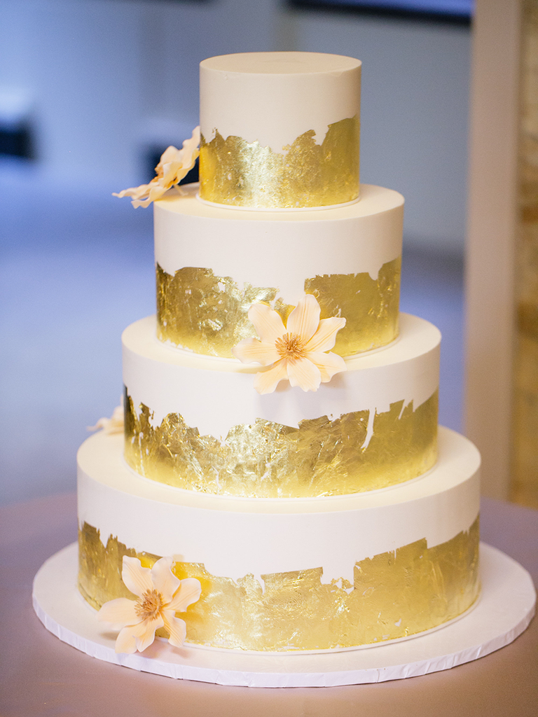 White wedding cake with gold foil decorations