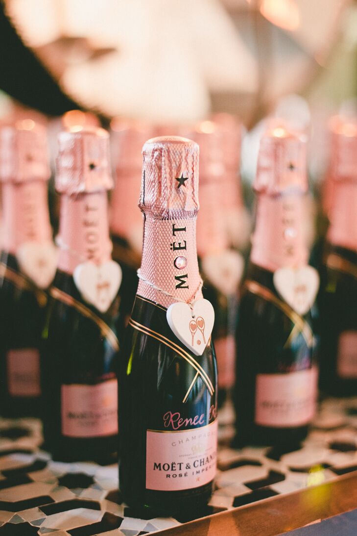 Patricia and Christopher ditched tradition and had fun with their escort cards, decorating mini Moet Rose champagne bottles with wooden hearts bearing a tennis racket motif. The bottles were displayed alongside a rose gold sign that read, “Time top pop champagne and drop it to the beat, but first find your seat.”