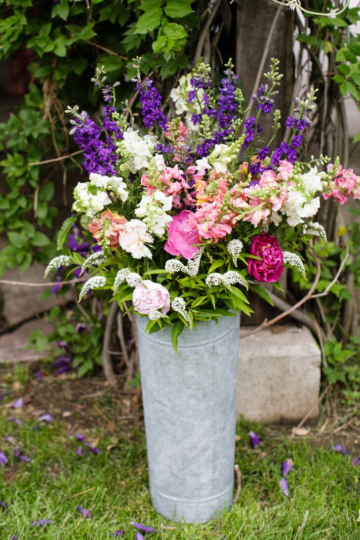 The bride purchased all of the flowers at a local farm and created the arrangements herself. "I did all of the table arrangements and altar the day before the wedding and had so much fun with it," she says. "It really didn't take a lot of time and turned out better than I expected."