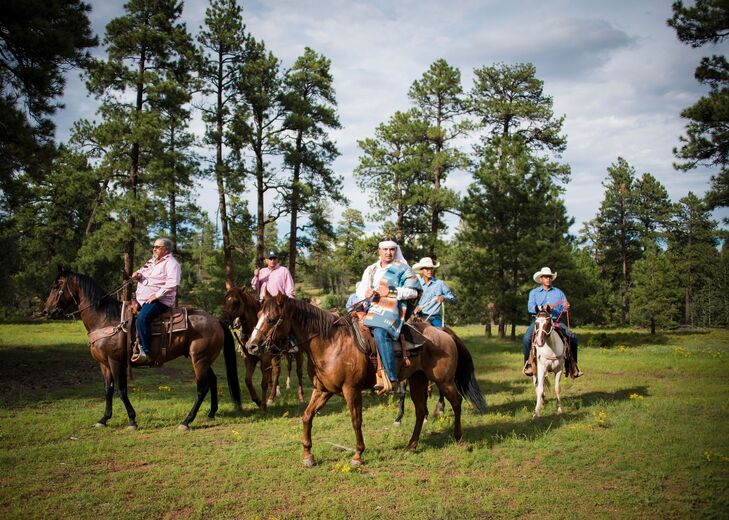 Groom in Traditional Native American Attire on Horseback With His Family Before Ceremony