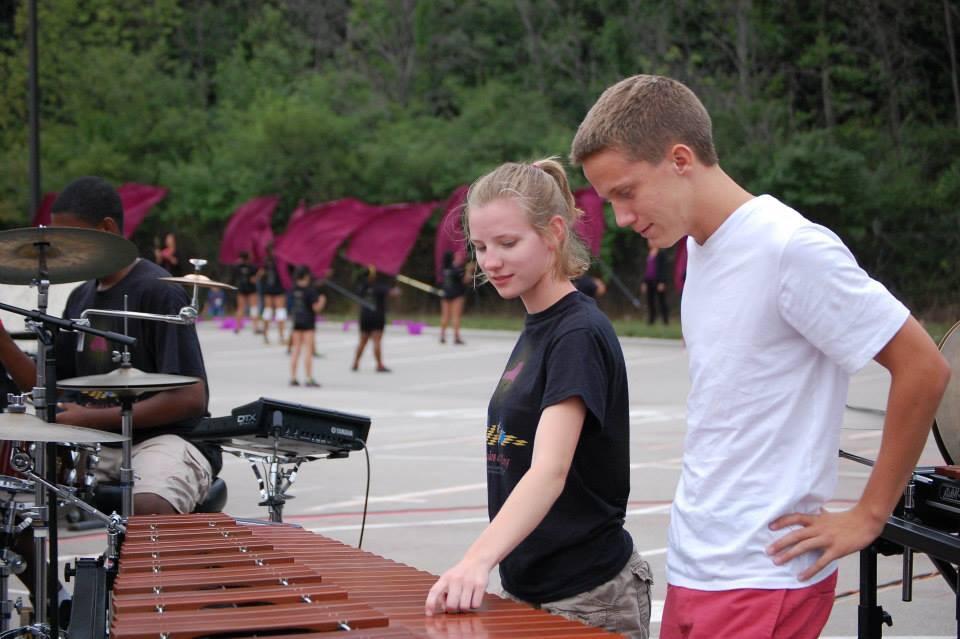 Alana teaching Alex about the marimba during LC's marching band parent preview night 