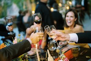 Guests Toast With Wine Glasses and Champagne Flutes at Reception Dinner