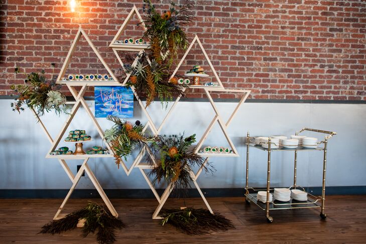 Christa, whose business is making custom wooden home furnishings, designed the triangular holders for the marble escort tiles. They were inscribed with guests names and doubled as favors.