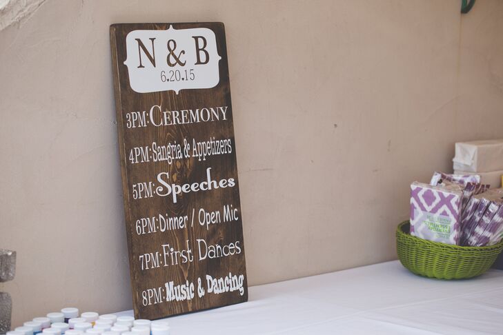 The ceremony schedule was painted on a large piece of wood, adding to the wedding's charming rustic decor.
