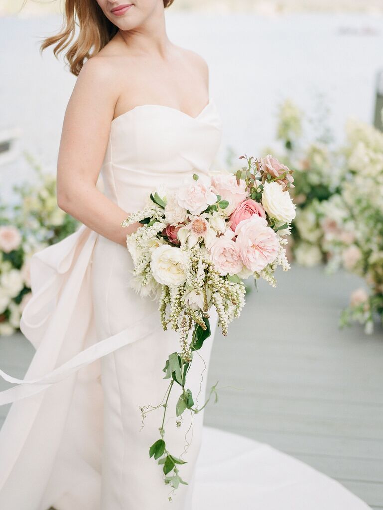 elegant cascading wedding bouquet with blush garden roses, pieris japonica, ivy vines and blushing bride proteas