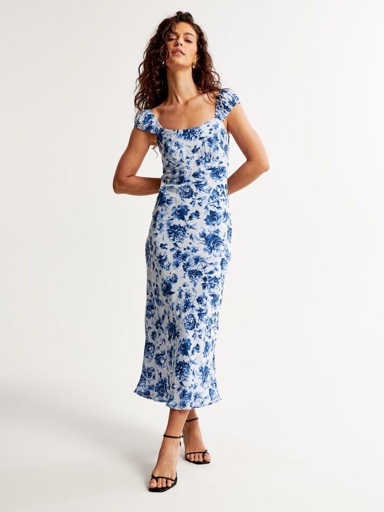 Model wears a patterned semi-formal slip dress by Abercrombie & Fitch. 