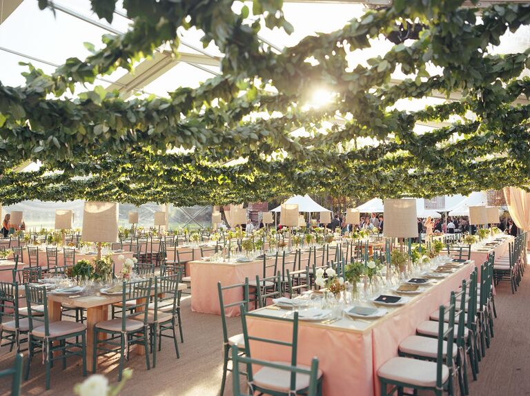 Wedding reception tent with a grid ceiling of lemon leaf garland