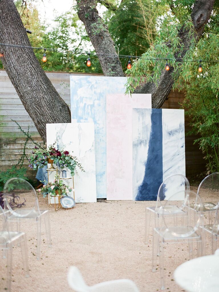 outdoor wedding ceremony altar with unique backdrop made from light pink and blue rectangular panels in different sizes